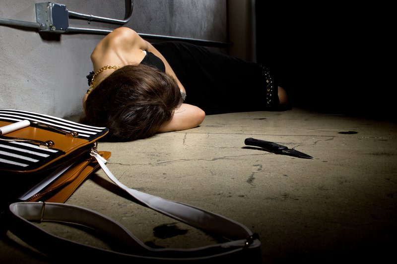 female laying dead on a street alley with a knife murder weapon